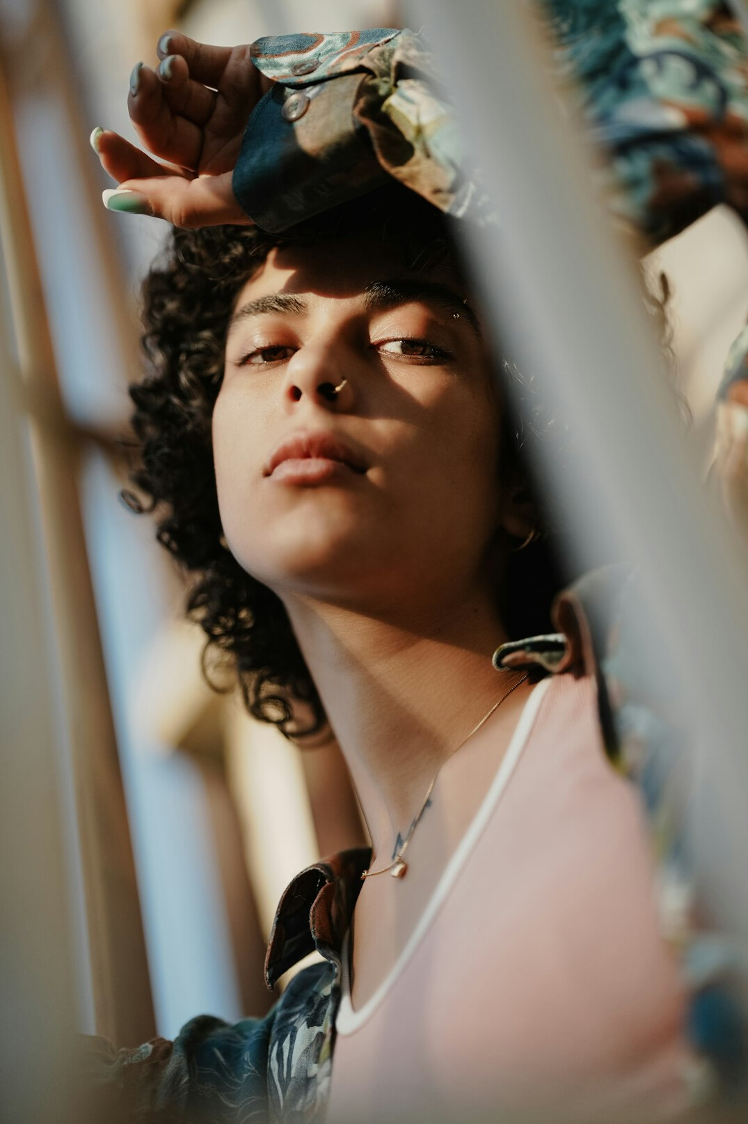 Portrait of a Black woman with curly hair holding a small camera