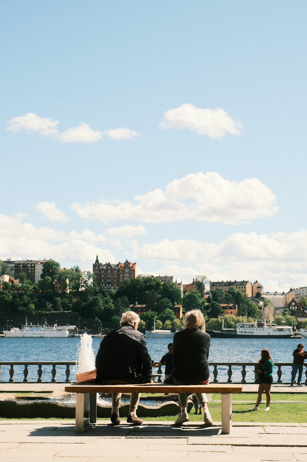 people chatting on a city bench