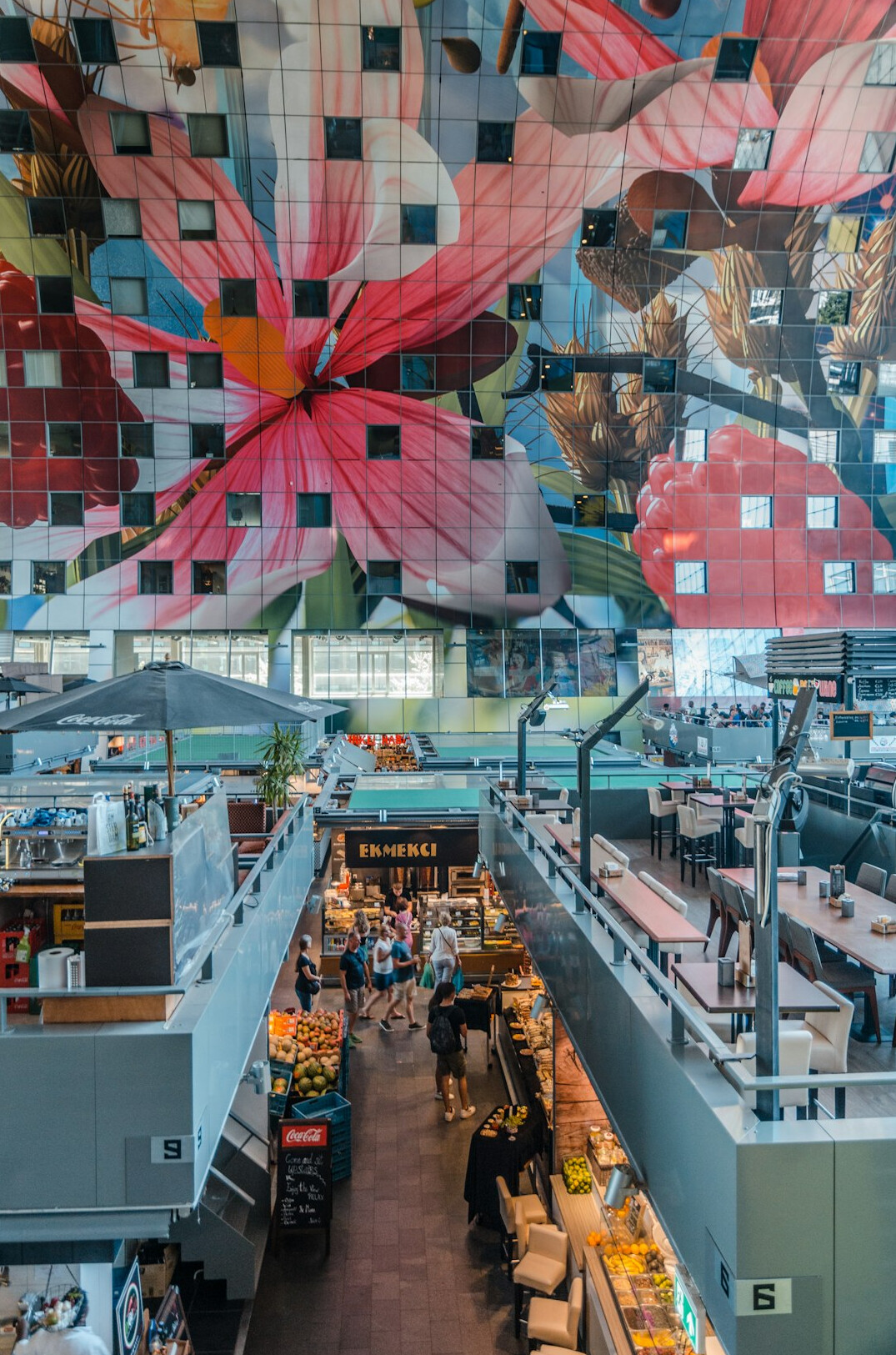 Overhead view of a busy food hall with people seated at tables