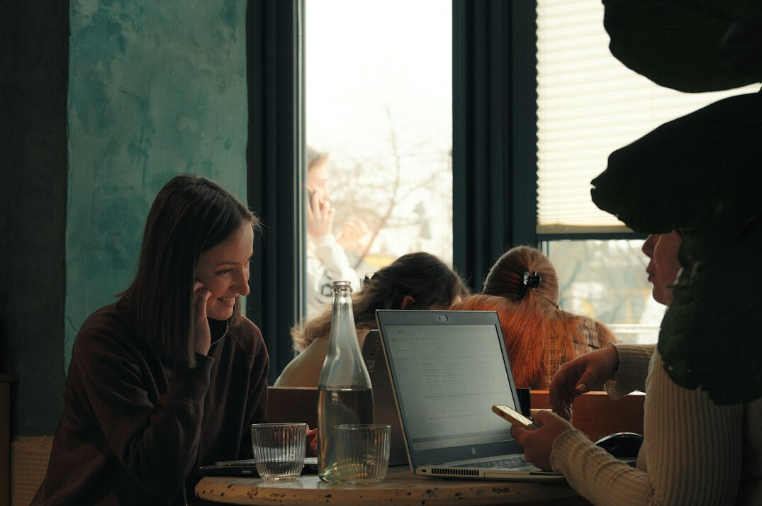 student studying with laptop in cafe