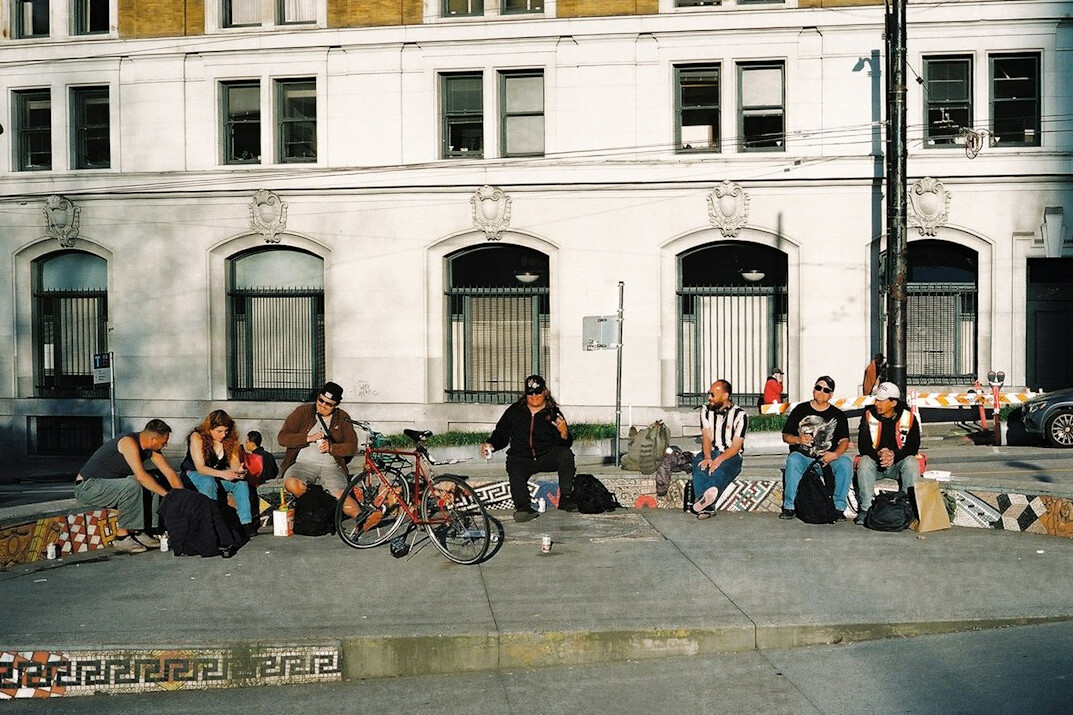 diverse group chatting on sidewalk