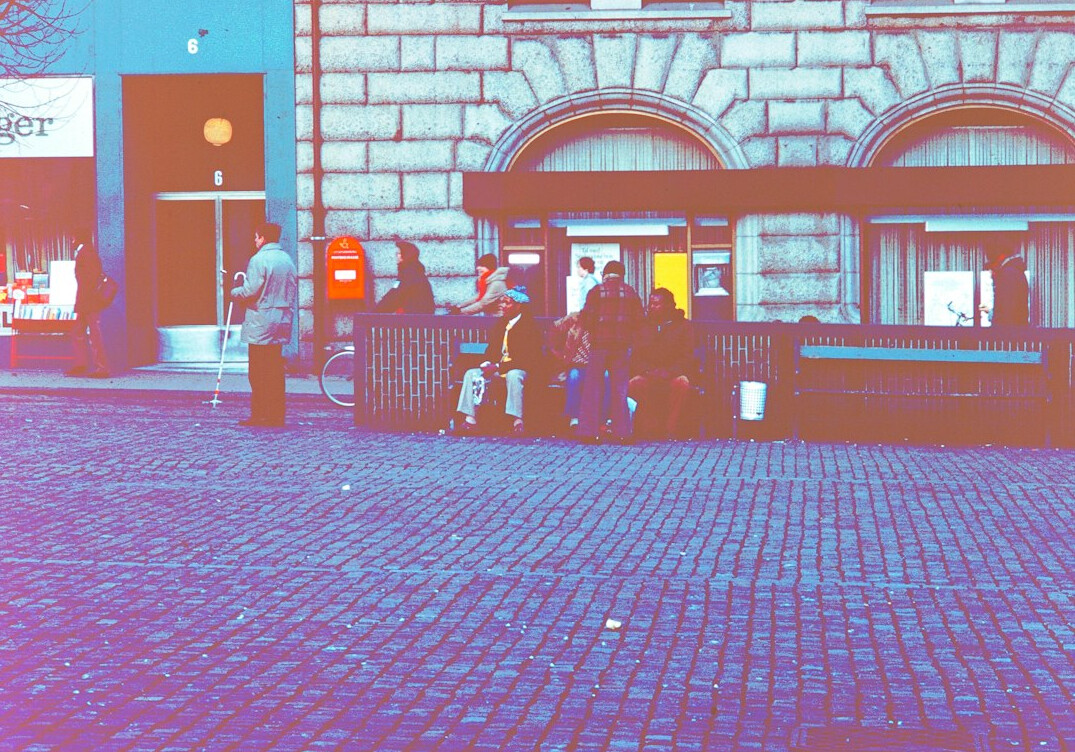 people chatting on a city bench